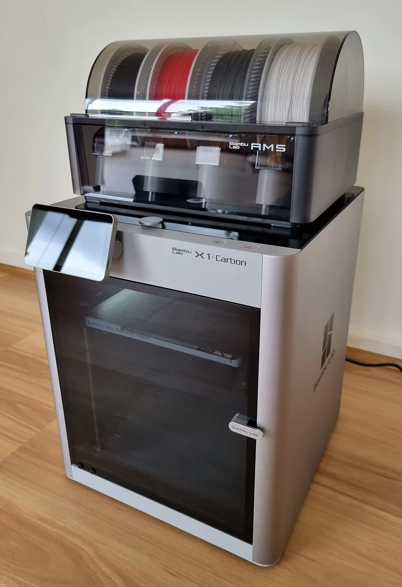 Bambu Lab X1-Carbon 3D printer with top-mounted AMS 4-spool module