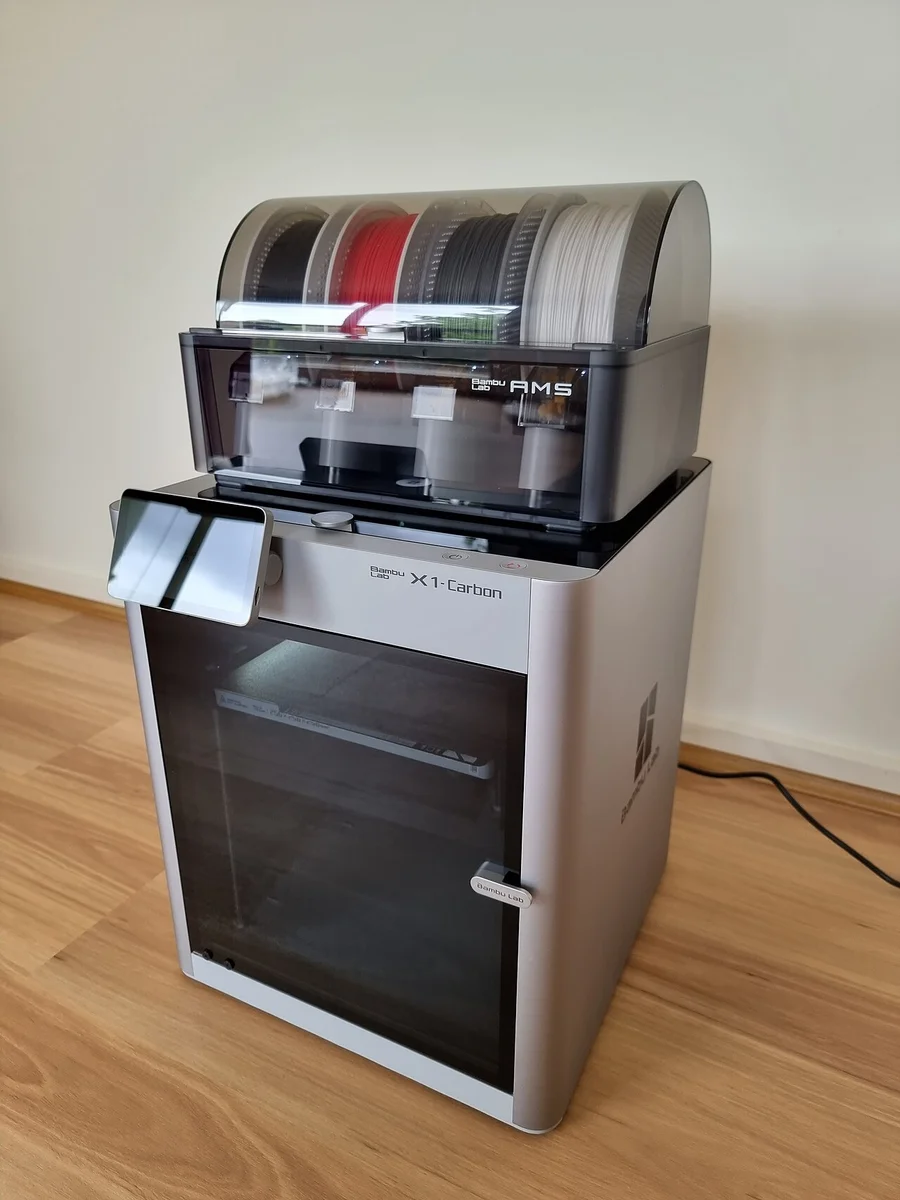 Bambu Lab AMS multi-material feeder loaded with four filament spools